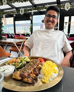 A guest enjoying a kebab platter at Fanoos