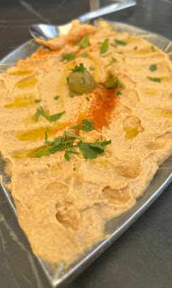 Freshly made hummus with olive oil and herbs